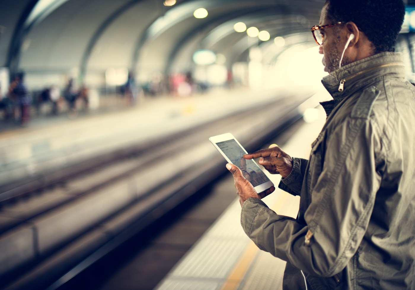 man on phone in subway tunnel