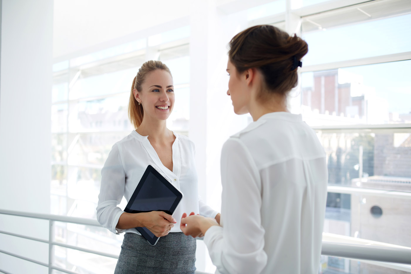 women talking in hallway